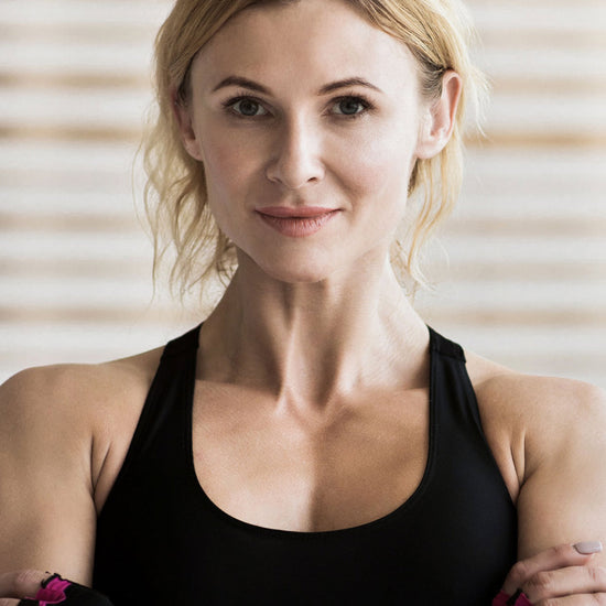 woman in a black tank top looking serious